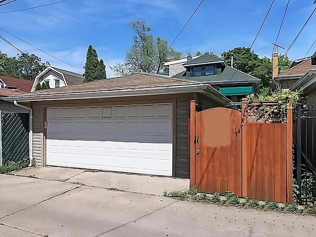 garage with fence and a gate