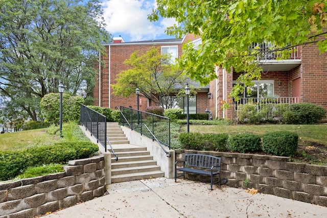 view of home's community with stairway and a patio area