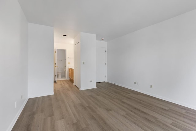 empty room with baseboards and wood finished floors