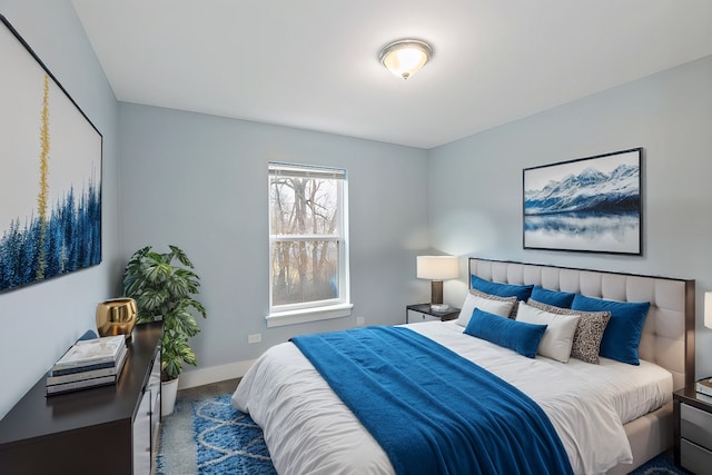 bedroom featuring carpet floors and baseboards