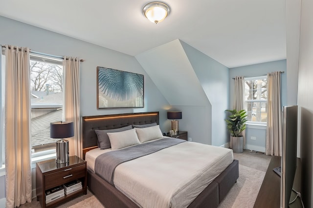 carpeted bedroom with vaulted ceiling and baseboards