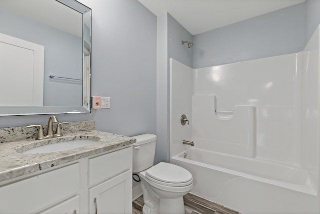 full bathroom with toilet, shower / bathtub combination, wood finished floors, and vanity