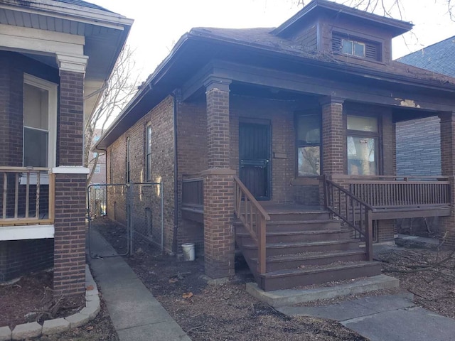 view of front of home with brick siding and covered porch