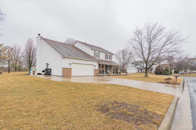 view of side of property with driveway, a yard, a garage, brick siding, and a chimney