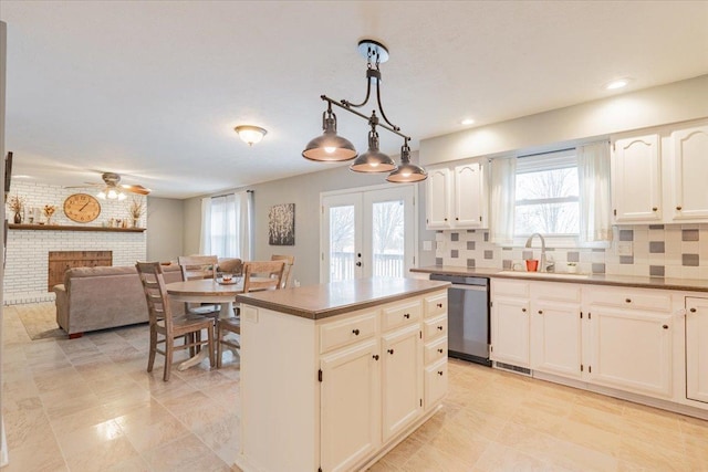 kitchen featuring a fireplace, a sink, french doors, dishwasher, and backsplash