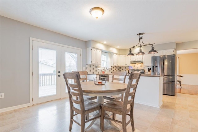 dining space featuring french doors and baseboards