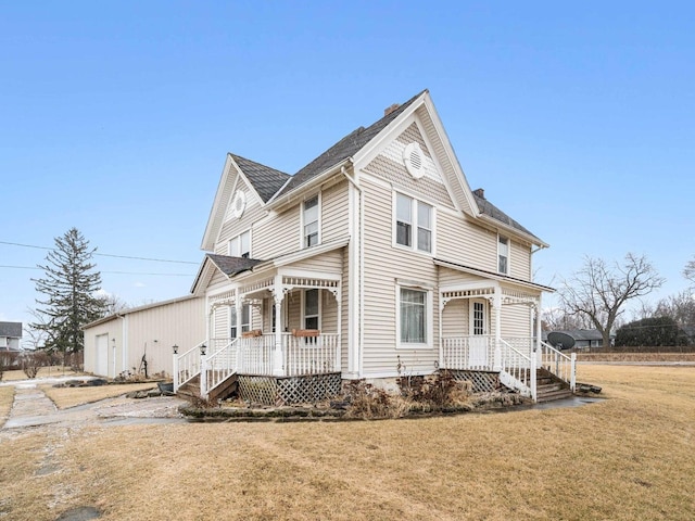 view of front of house with covered porch and a front yard