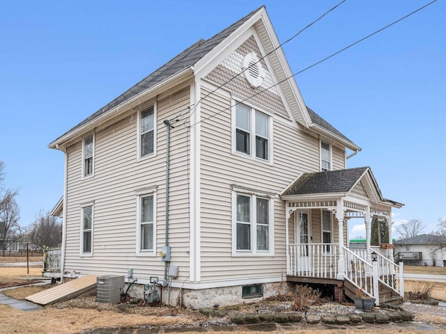 victorian house with covered porch and central air condition unit