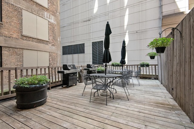 deck featuring grilling area and outdoor dining area