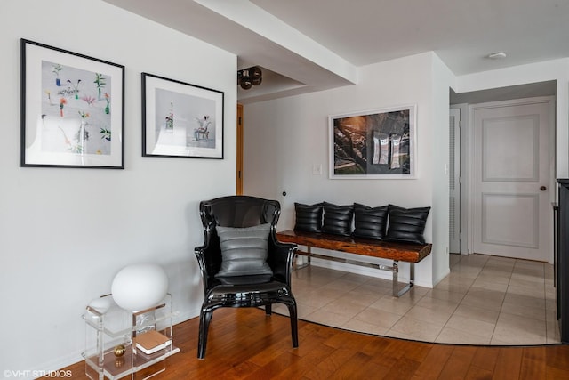 living area with baseboards and wood finished floors