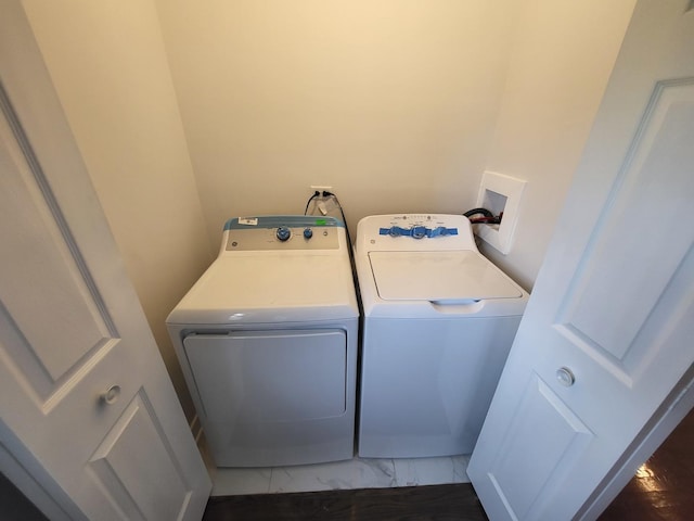 clothes washing area featuring laundry area, marble finish floor, and separate washer and dryer