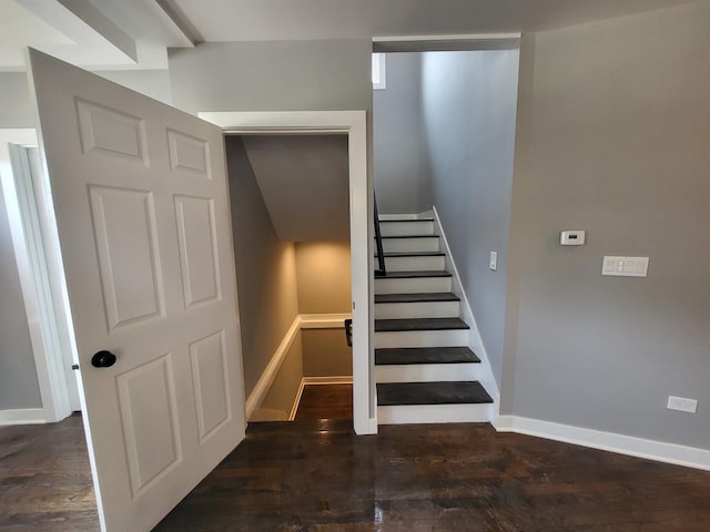 stairway with baseboards and wood finished floors
