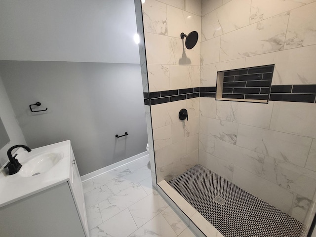 full bathroom featuring toilet, vanity, baseboards, marble finish floor, and tiled shower