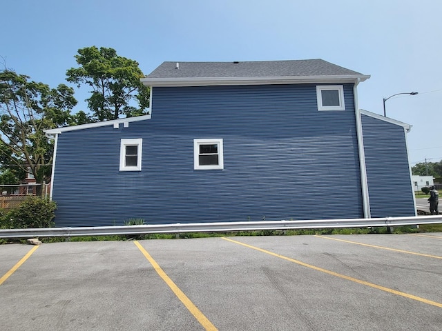 view of side of property featuring uncovered parking