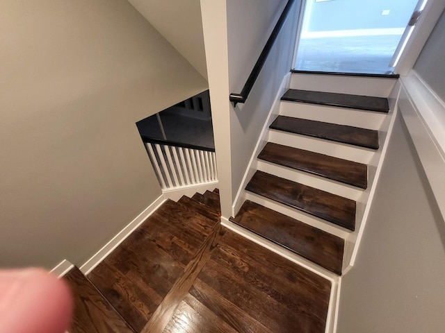 stairs with wood finished floors and baseboards