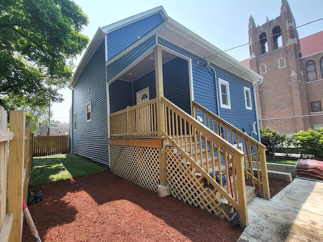 back of house with fence