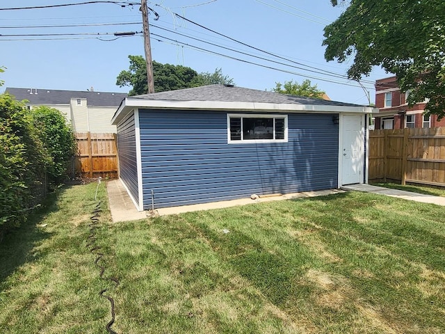 view of outdoor structure featuring an outbuilding and a fenced backyard