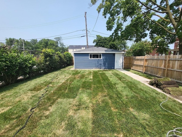 view of yard with fence and an outbuilding