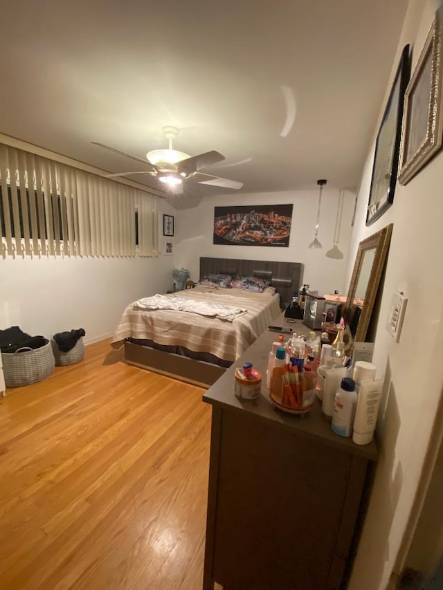 bedroom featuring wood finished floors and a ceiling fan