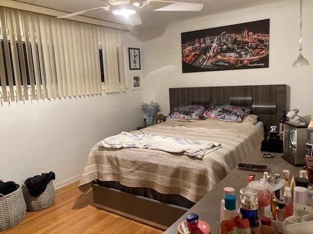 bedroom featuring a ceiling fan and wood finished floors