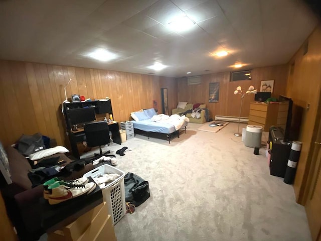 carpeted bedroom featuring wooden walls and baseboard heating