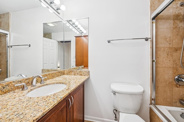 full bath featuring vanity, toilet, and tiled shower / bath