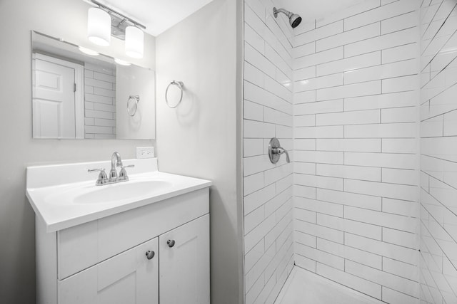 full bath with vanity and tiled shower