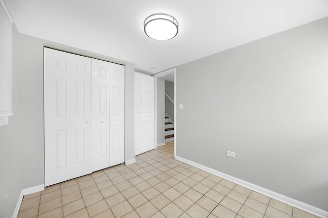 unfurnished bedroom featuring a closet and baseboards