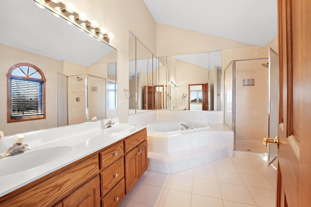 bathroom with vaulted ceiling, a stall shower, a garden tub, and a sink