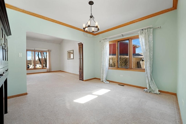 unfurnished room featuring a notable chandelier, carpet flooring, baseboards, and ornamental molding