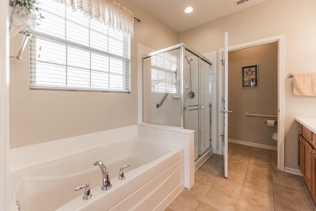 full bathroom featuring vanity, visible vents, a stall shower, tile patterned flooring, and a bath