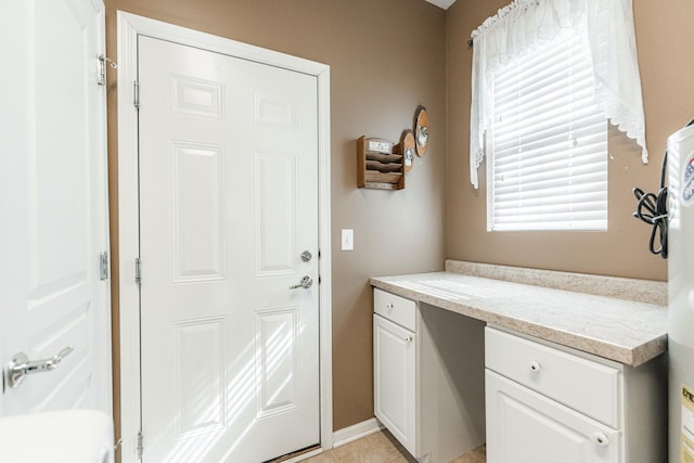 doorway to outside with light tile patterned floors and baseboards