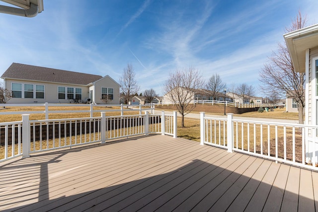 wooden deck with a residential view and fence