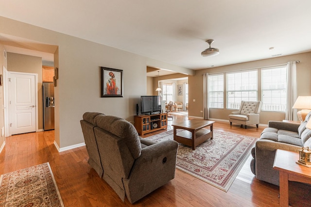 living area with baseboards and light wood-style floors