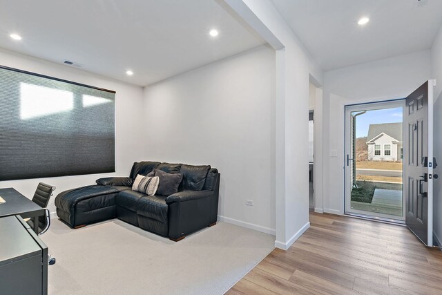 bedroom with visible vents, light colored carpet, baseboards, and a ceiling fan