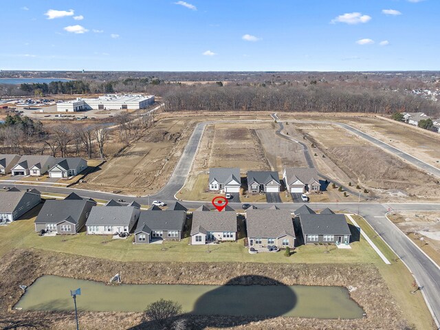 view of front of property with brick siding, a front lawn, aphalt driveway, and a garage