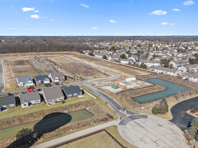 ranch-style home featuring brick siding, a shingled roof, aphalt driveway, a front yard, and an attached garage