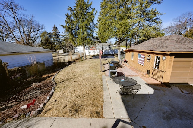 view of yard featuring a patio, an outdoor structure, and fence