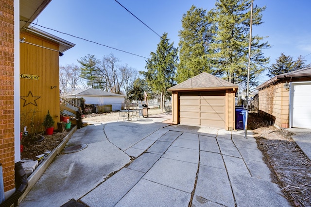 detached garage featuring fence