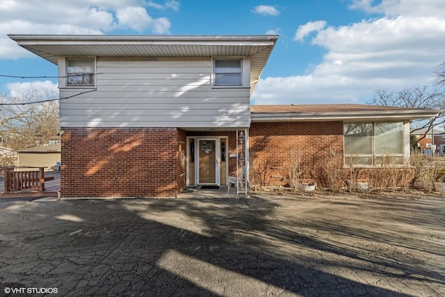 back of house with brick siding