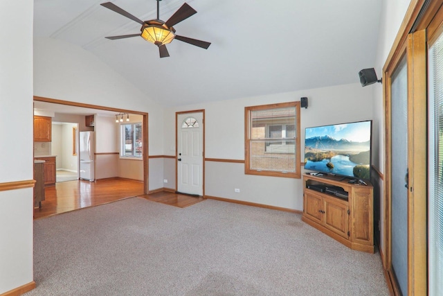 unfurnished living room featuring baseboards, light carpet, lofted ceiling, and a ceiling fan