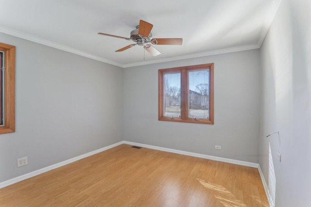 empty room with visible vents, crown molding, baseboards, light wood-type flooring, and a ceiling fan