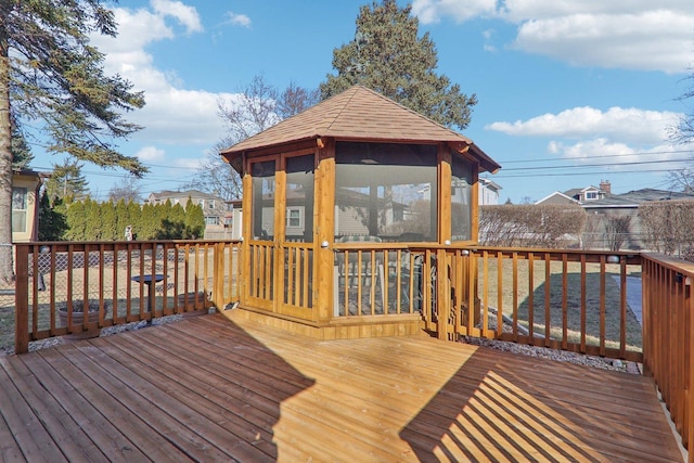 wooden deck featuring a sunroom