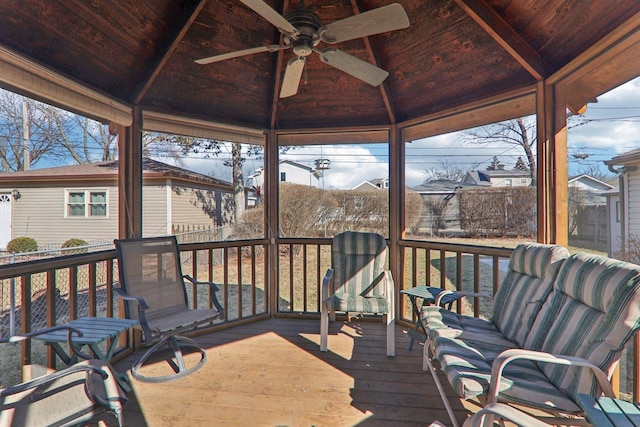 wooden terrace featuring a gazebo and ceiling fan