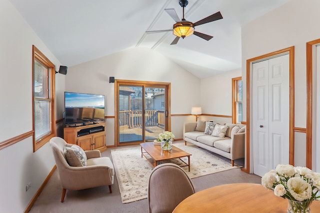 carpeted living area featuring a wealth of natural light, baseboards, a ceiling fan, and lofted ceiling