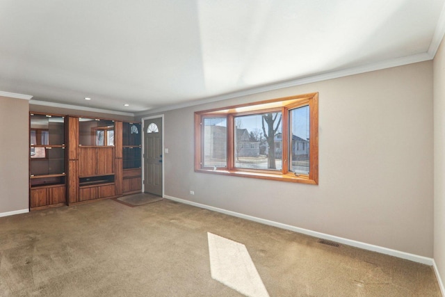 unfurnished living room featuring baseboards, carpet floors, visible vents, and crown molding