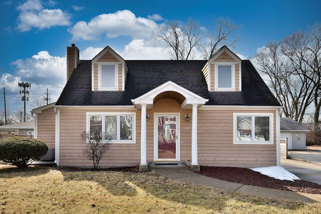 cape cod-style house featuring a chimney and roof with shingles