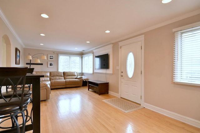 entrance foyer featuring a healthy amount of sunlight, light wood-type flooring, and baseboards