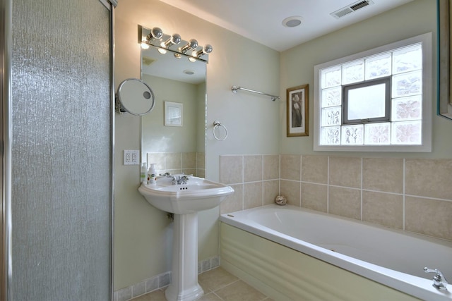 full bathroom with a sink, visible vents, a garden tub, and tile patterned flooring