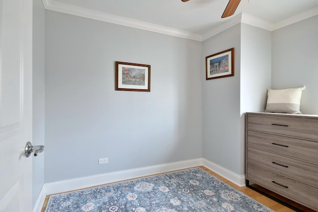 bedroom with baseboards, light wood-style floors, ceiling fan, and crown molding